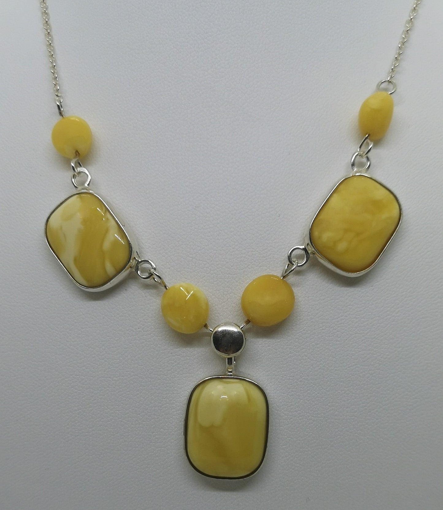 Sterling silver chain with 7 butterscotch amber stones either set in a setting or with a wire through it