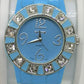 Blue fashion bangle style watch with silicone strap and cubic zirconia's around the face